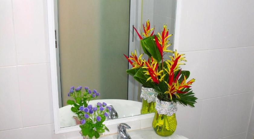 a bathroom sink with a vase of flowers in it, Chawlay Resort in Ko Lipe