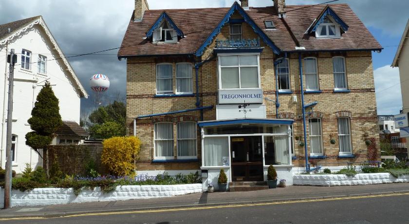 a white and blue house with a blue roof, Tregonholme Hotel in Bournemouth