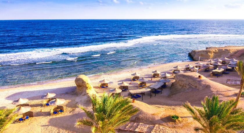 a beach with a beach chair and some sand, Jaz Lamaya Resort - All Inclusive in Qesm Marsa Alam