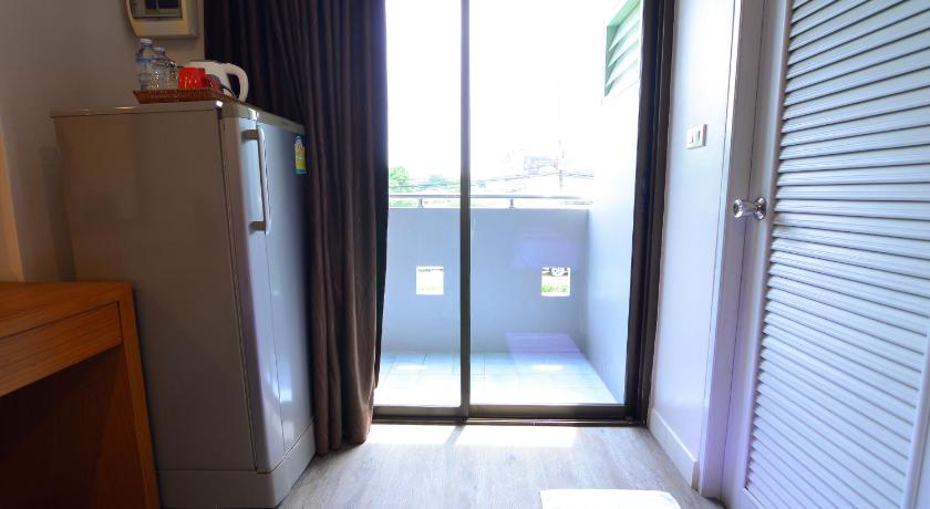 a white refrigerator in a room with a window, BJ Boutique in Rayong