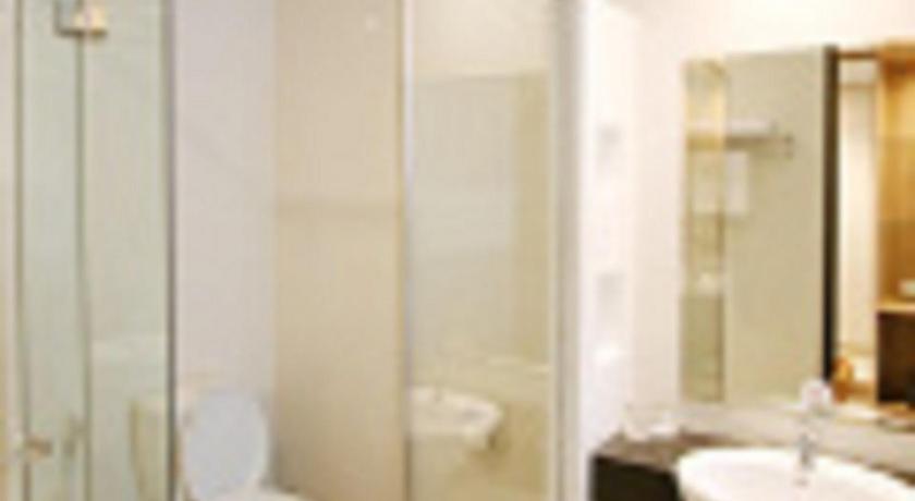 a bathroom with a shower, toilet and sink, Pasar Baru Square Hotel Bandung in Bandung