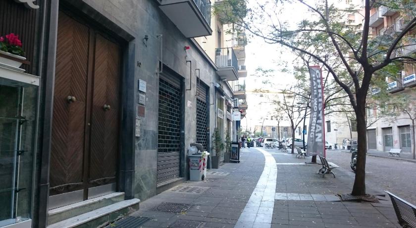 a city street with a sidewalk and a building, Guantai 30 in Naples