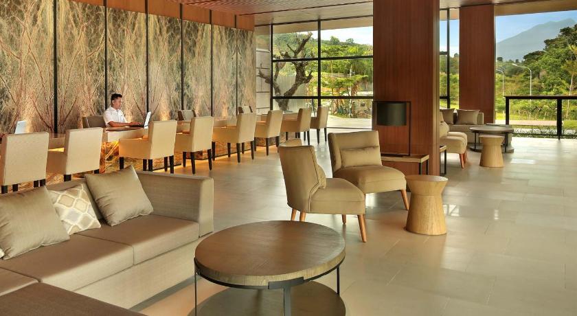 a living room filled with chairs and tables, Royal Tulip Gunung Geulis Resort and Golf in Puncak