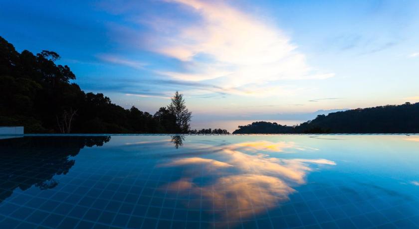 a large pool of water in front of a blue sky, Amala Grand Bleu Resort in Phuket
