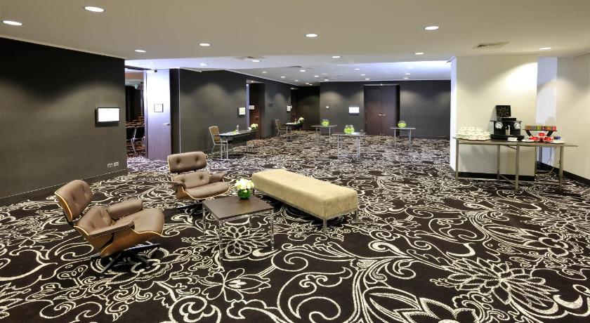 a hotel room with a large bed and a rug, Novotel Melbourne on Collins in Melbourne