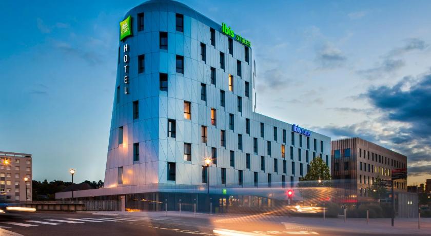 a large building with a clock on the side of it, Ibis Styles Mulhouse Centre Gare in Mulhouse