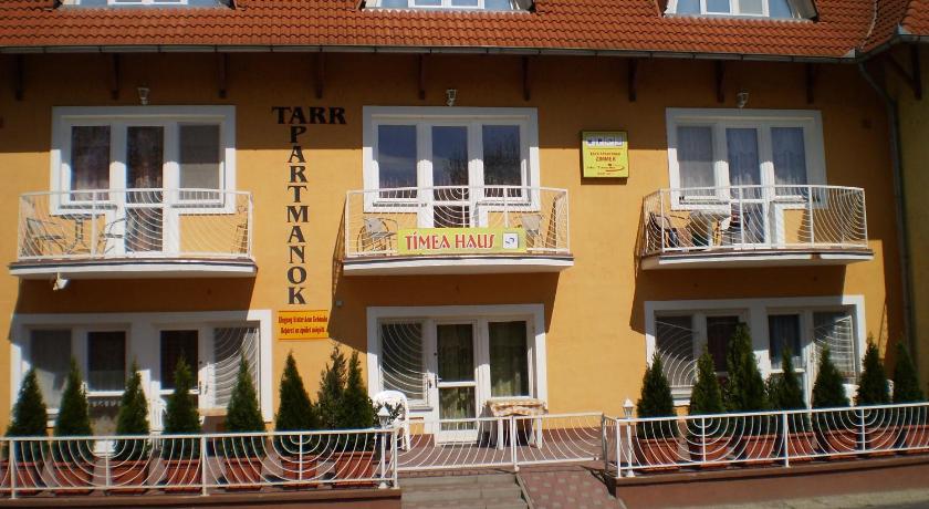 a large white building with a large window, Tarr Apartmanok, Timea Haus in Keszthely