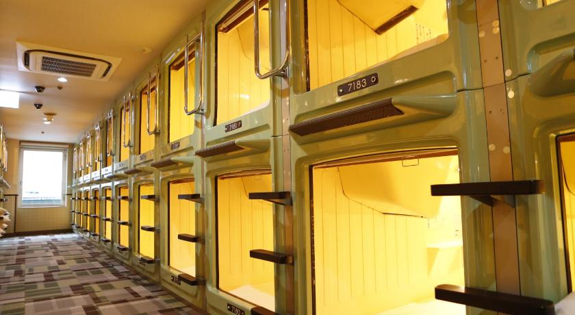 the inside of a train station with a lot of doors, Shinjuku Kuyakusho-mae Capsule Hotel in Tokyo