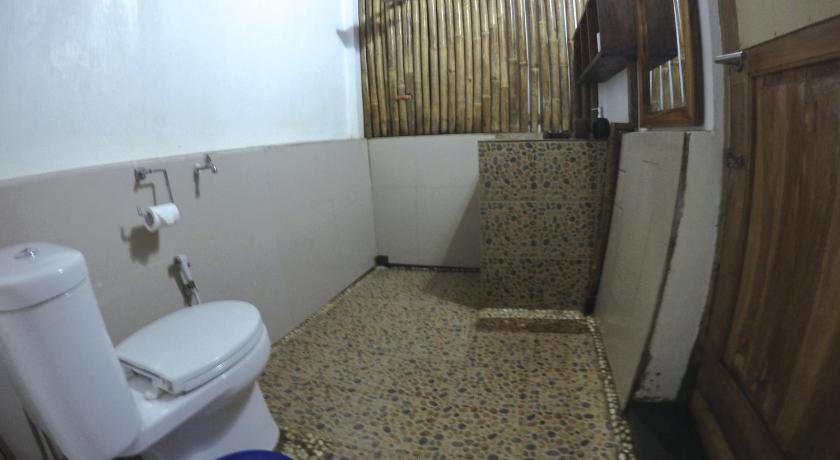 a bathroom with a toilet, sink, and shower stall, Villa Monyet Java in Pangandaran