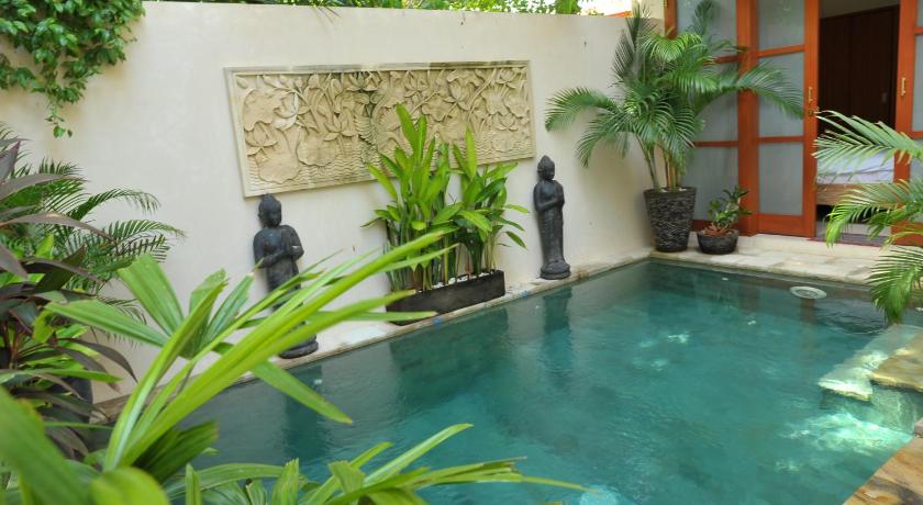 a swimming pool with a pool table and chairs, Villa Ngetis in Bali