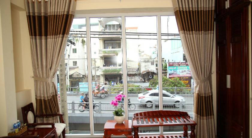 a living room filled with furniture and a window, Minh Tam Hotel and Spa in Ho Chi Minh City