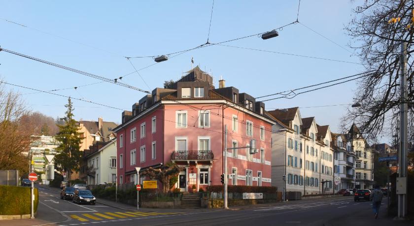 a large building on the corner of a street, California House in Zürich
