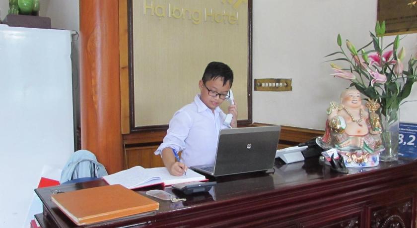 a man sitting at a desk in front of a computer, Viet Nhat Halong Hotel  in Hạ Long