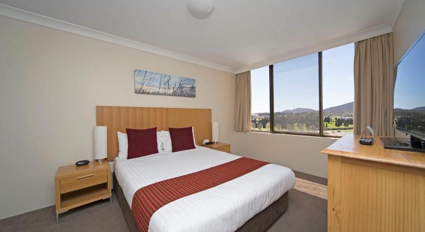a hotel room with a bed and a desk, BreakFree Capital Tower Canberra in Canberra