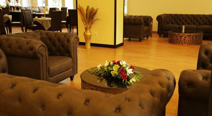 a living room filled with furniture and a couch, GHS Hotel in Brazzaville