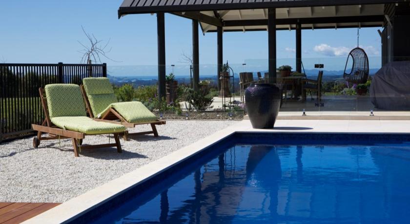 a patio area with chairs, a pool and a pool table, Lodore Lodge in Kerikeri