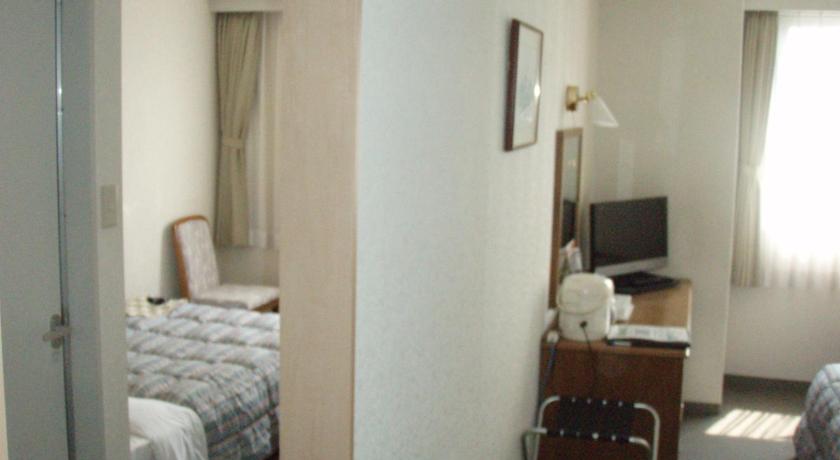 a hotel room with a bed and a television, New Royal Hotel Shimanto in Shimanto