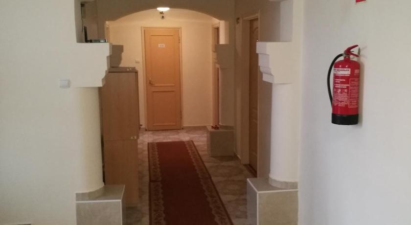 a hallway with a door leading to a room with a rug, Matyas Szallas in Szombathely