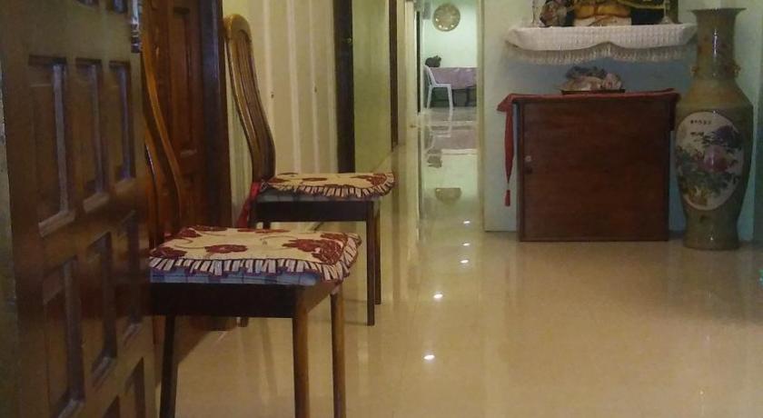 a living room filled with furniture and a rug, Dwellers Pensione in Iloilo