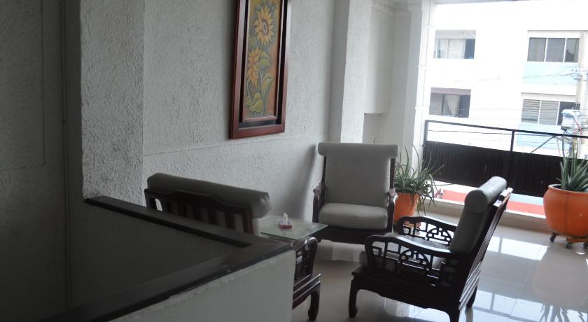 a living room filled with furniture and a window, Hotel San Marcos Barranquilla in Barranquilla