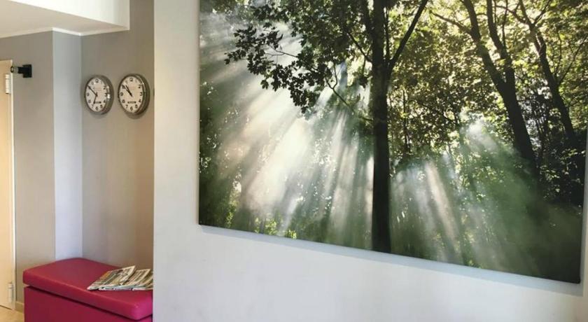 a room with a painting on the wall and a painting on the wall, Privilege Apartments in Vimercate