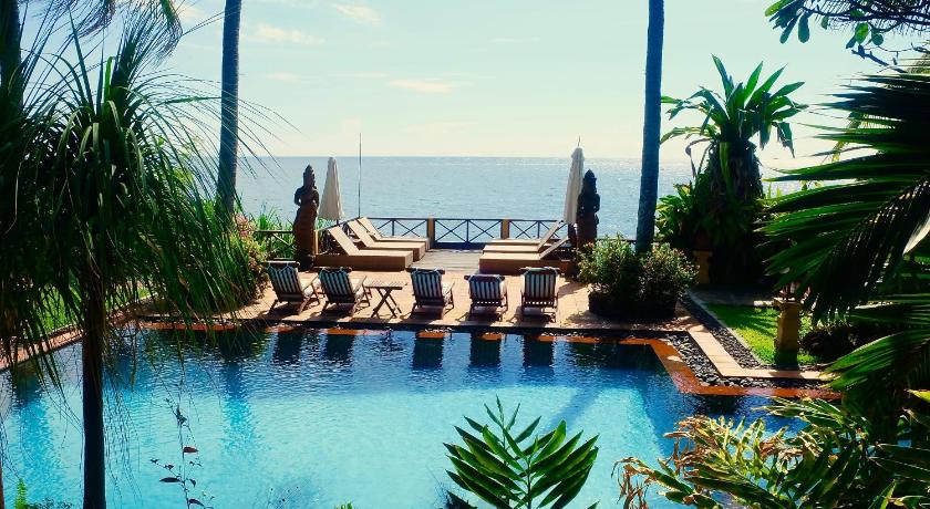 a beach with palm trees and palm trees, Villa Boreh Beach Resort & Spa in Bali