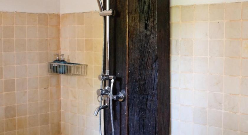 a door is open to a bathroom with a shower, Rumah Jah Langkawi in Langkawi
