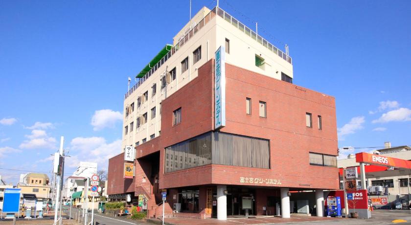 a large building with a clock on the side of it, Fujinomiya Green Hotel in Gotemba