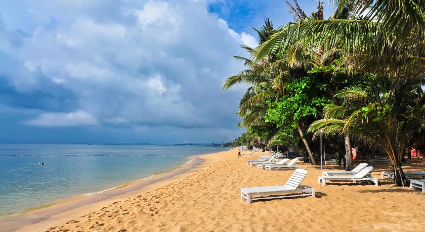 a beach with a beach chair and beach umbrellas, Sea Star Resort in Phu Quoc Island