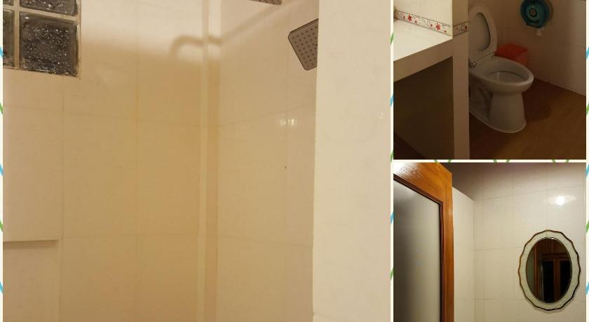 a bathroom with a sink, toilet and a shower curtain, Tarahill Khao Kho in Khao Kho