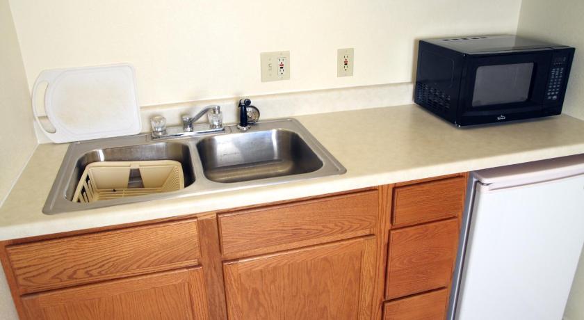 a kitchen with a sink and a microwave, Country Inn Motel in Dove Creek (CO)