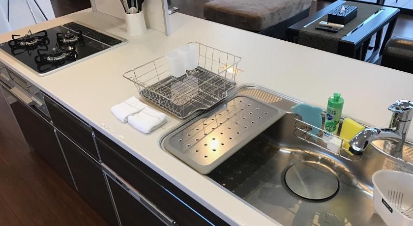 a kitchen sink with a stainless steel counter top, Kouri Ocean Villa in Okinawa Main island