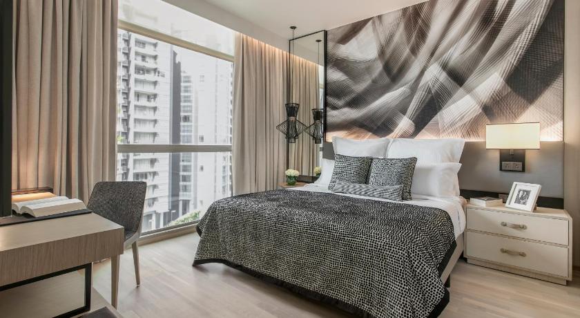 a bedroom with a large bed and a large window, Ascott Orchard Singapore (SG Clean Certified) in Singapore