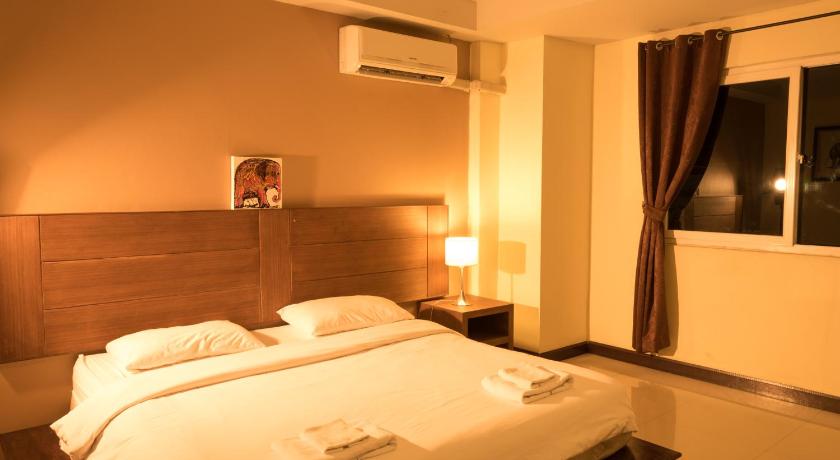 a hotel room with a bed and a television, THE SQUARE RAYONG in Rayong