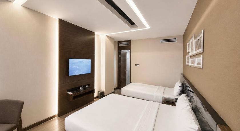 Image of Superior Triple Room with One Queen and One Single Bed 1