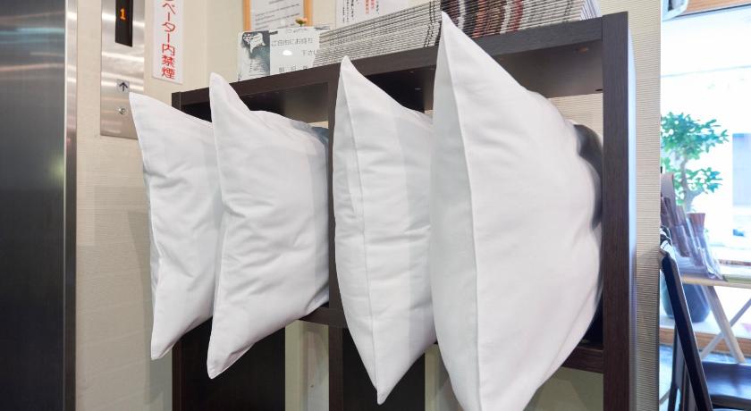 a white towel hanging from a rack on a wall, Hotel Select Inn Yaizu Ekimae in Shizuoka