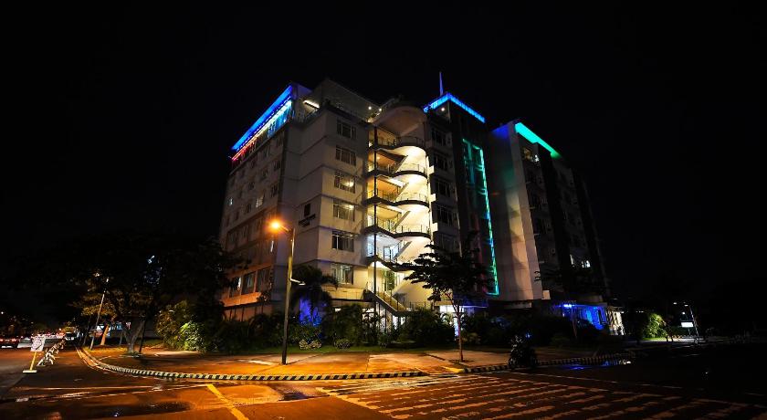 a large building with a clock on the side of it, Paseo Premiere Hotel by Cocotel Powered by ASTON in Laguna