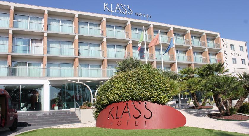 a large building with a clock on the front of it, Klass Hotel in Castelfidardo