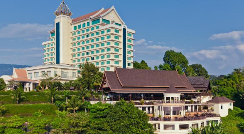 a large building with a clock on the top of it, Champasak Grand Hotel in Pakse