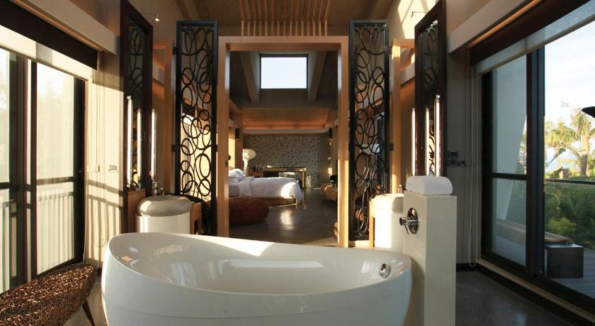 a bathroom with a tub and a bathtub in it, The House 15 Villa in Kenting