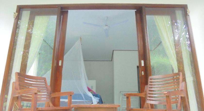a room with chairs, a table and a mirror, Pondok Salacca#bamboohouse# in Bali