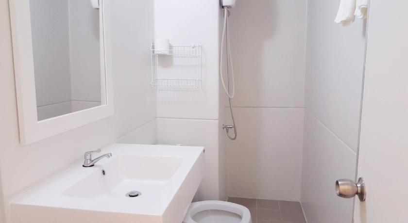a bathroom with a sink, toilet and mirror, Condo C4 IMPACT in Bangkok
