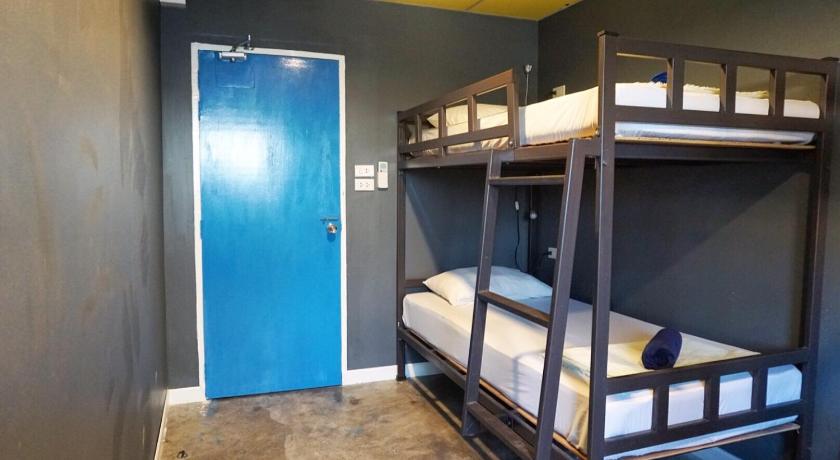 a bunk bed in a small room with a wall behind it, B&B House & Hostel in Krabi