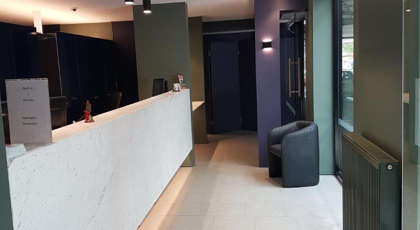 a bathroom with a walk in shower next to a walk in closet, Belconnen Way Hotel & Serviced Apartments in Canberra