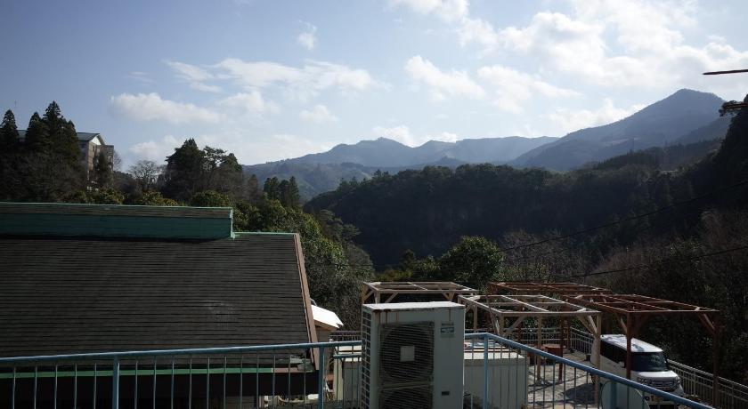 a large building with a view of mountains, Kashi Besso Takachiho in Takachiho