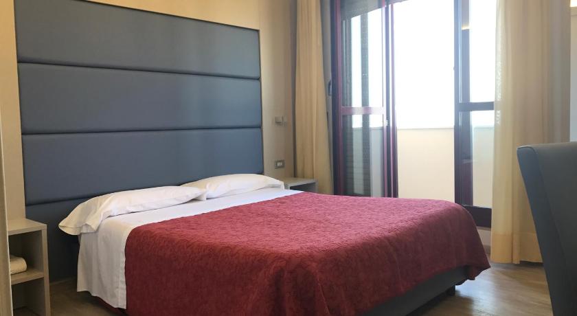 a hotel room with a bed and a desk, Hotel Elisabeth Due in Fano