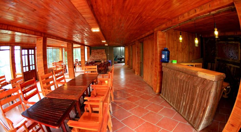 a kitchen with wooden floors and wooden tables, Po TaVan Homestay in Sapa