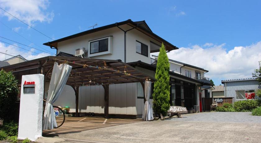 a house that has a garage door open, Guest House Asora in Aso