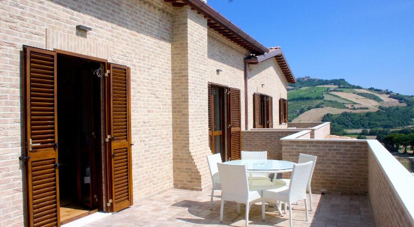 a patio area with a table and chairs, Moresco Agriturismo in Moresco