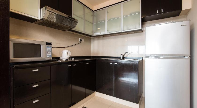 a kitchen with a refrigerator, microwave, sink and dishwasher, New Town Suites in Kuala Lumpur